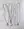 Four WALD Berlin necklaces are displayed on marble: two with smiley pendants, one 