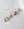 Four pairs of WALD Berlin earrings, including the Pop Wave Earrings Small in gold and abstract shapes with 925 silver pin posts, are arranged on a white marble surface.