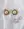 Gold earrings with sunburst designs and large central pearls rest on a white cloth beside two WALD Berlin Pop Pearl Rings, all crafted from 18k gold plated brass for a modern look.