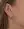 A woman's ear adorned with a pair of WALD Berlin earrings from Germany.