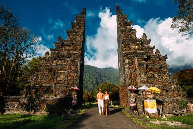 Beautiful couple at the Bali temple. Man and woman traveling in Indonesia. Couple at the Bali gate. The couple travels the world. Travel to tourist places in Asia. Tourists in Bali. Copy space.