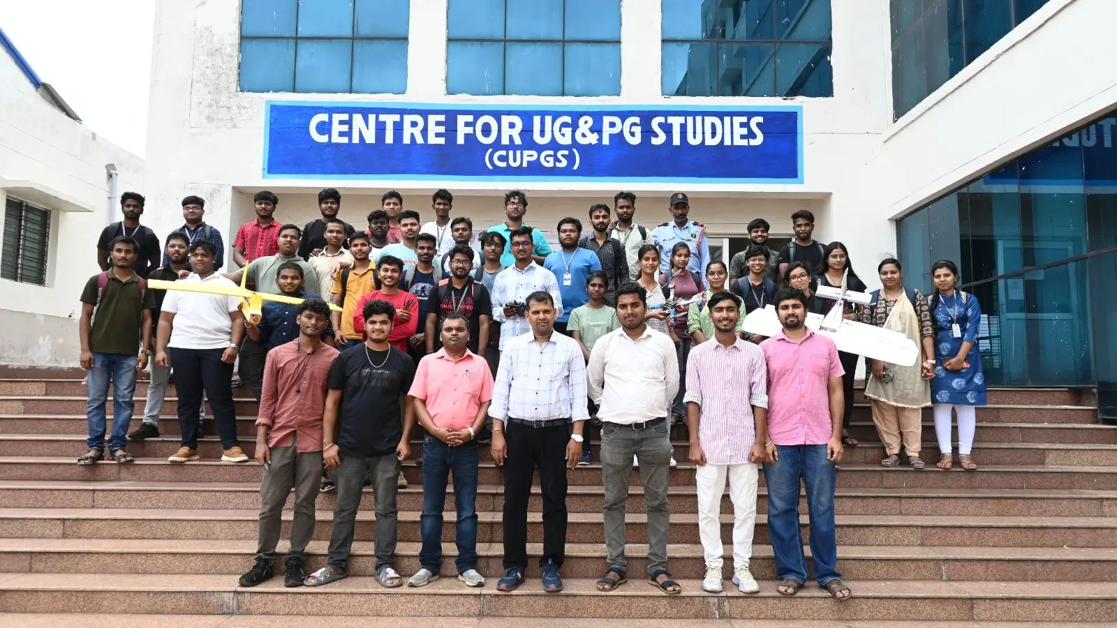 Students at CUPGS holding a prototype aircraft