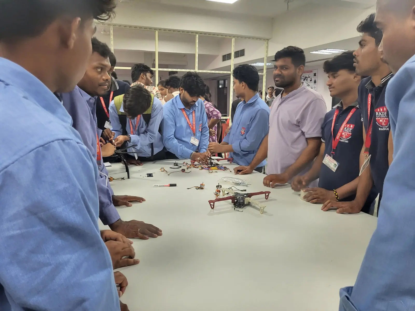 Workshop team reviewing components around a table