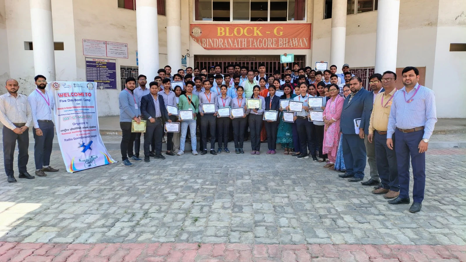 Participants holding completion certificates at the ceremony