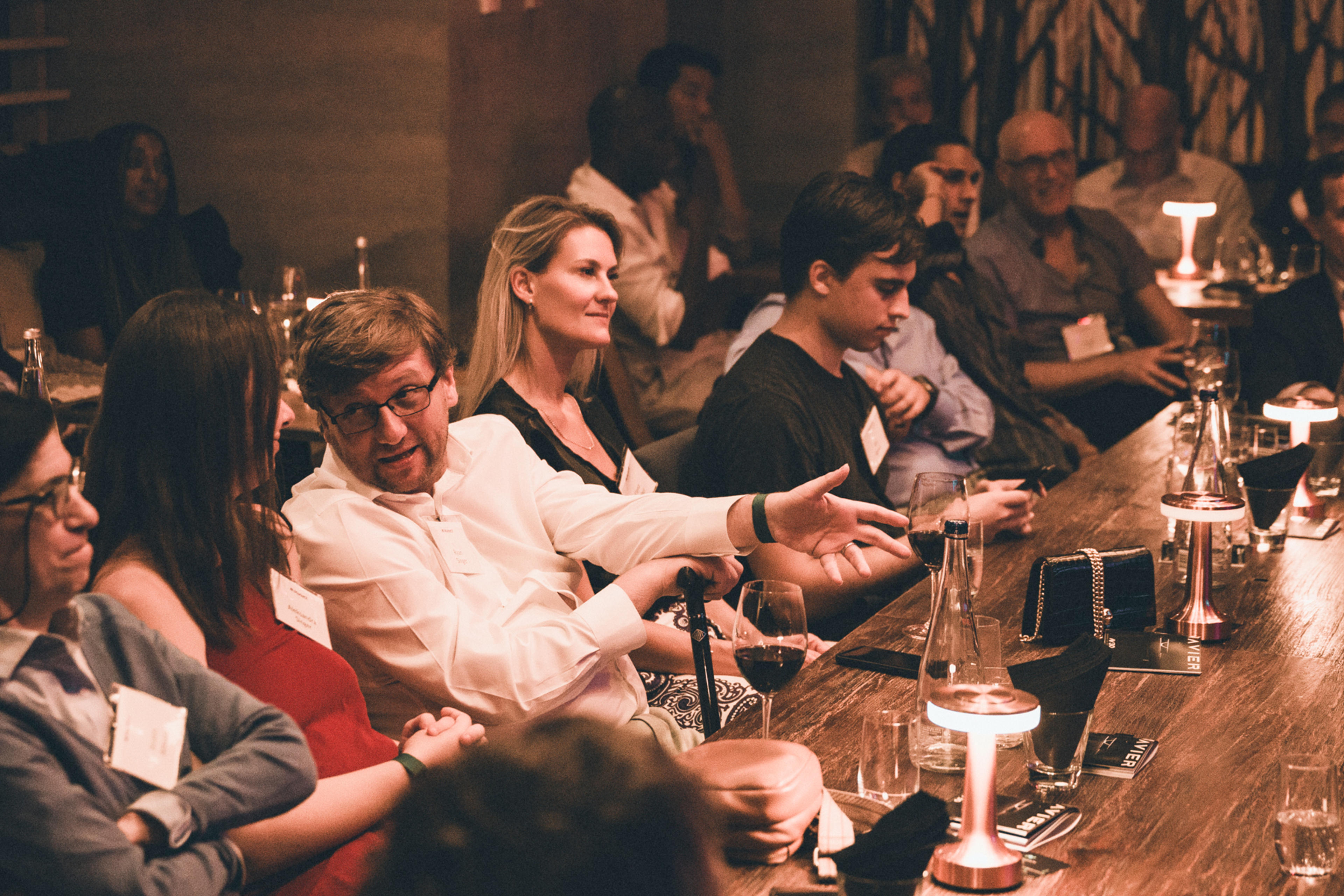 Image 3: A candid shot of guests engaged in conversation, enjoying the evening.