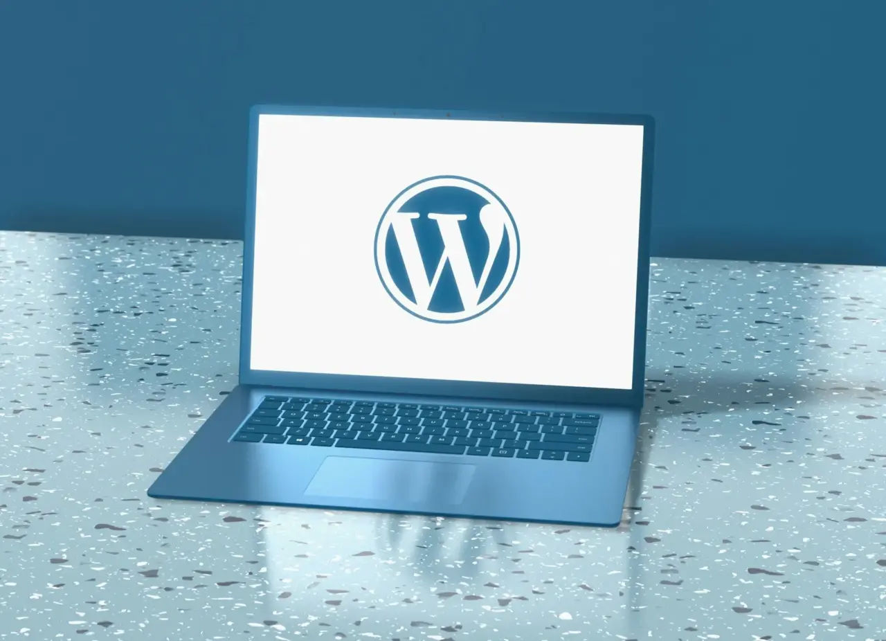 Laptop showing wordpress logo on a table