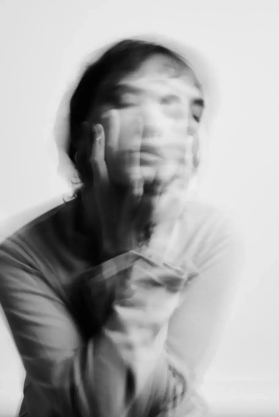 Blurred image of a person's face, giving a sense of movement.