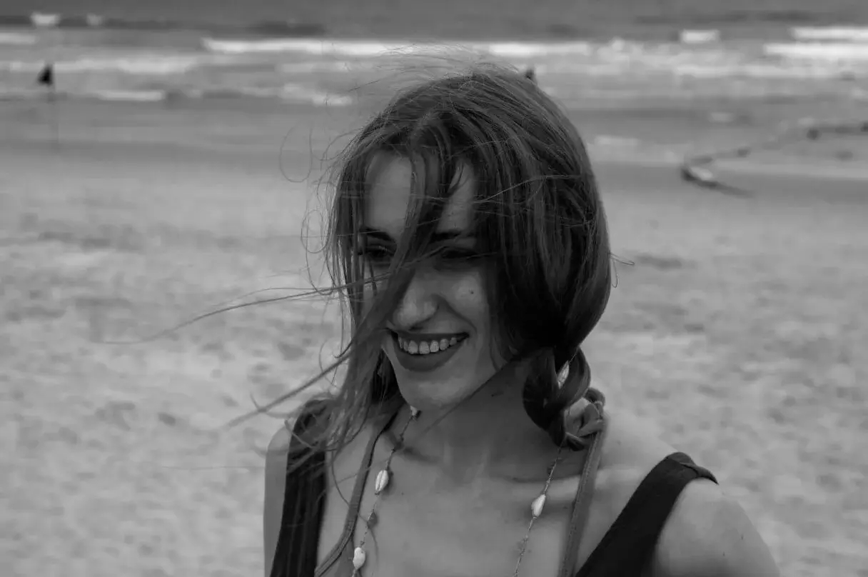 Woman smiling in a wheat field.