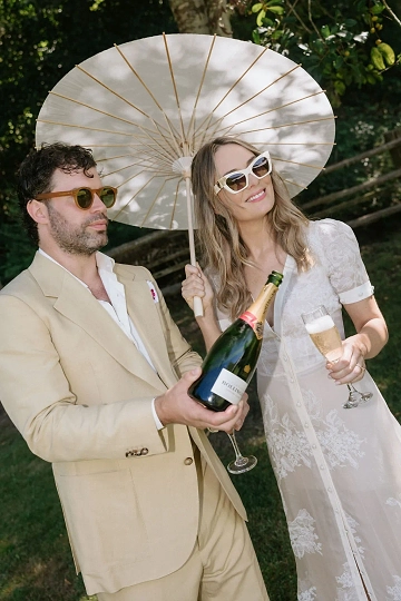A couple celebrate making things official with a glass of champagne on the grounds of their stunning Central Coast wedding venue.