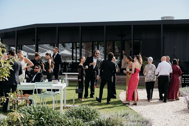 Guests enjoying drinks and canapes on the manicured lawns at Rowlee Wines.