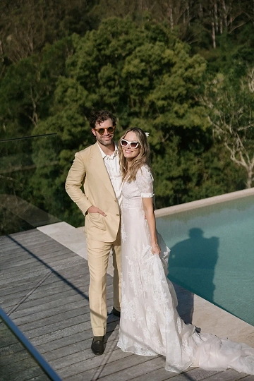 A couple have their photo taken beside the infinitely pool at Bebeah Farm.
