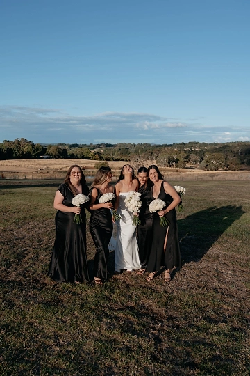 A bride and her bridesmaids having their photo taken at Rowlee Wines.