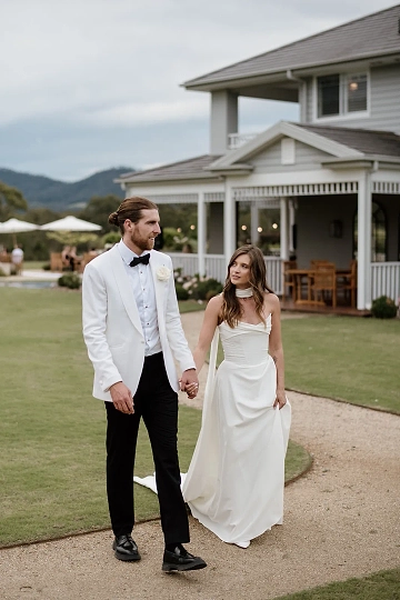 A couple having a quiet moment together with their beautiful Kangaroo Valley wedding venue in the background.
