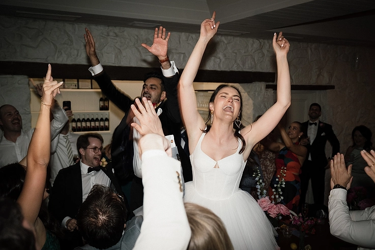 Let the party begin - bride and groom let their hair down