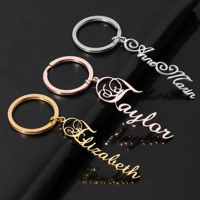 Script Name Keychain With Decorative Swirl Above Initial