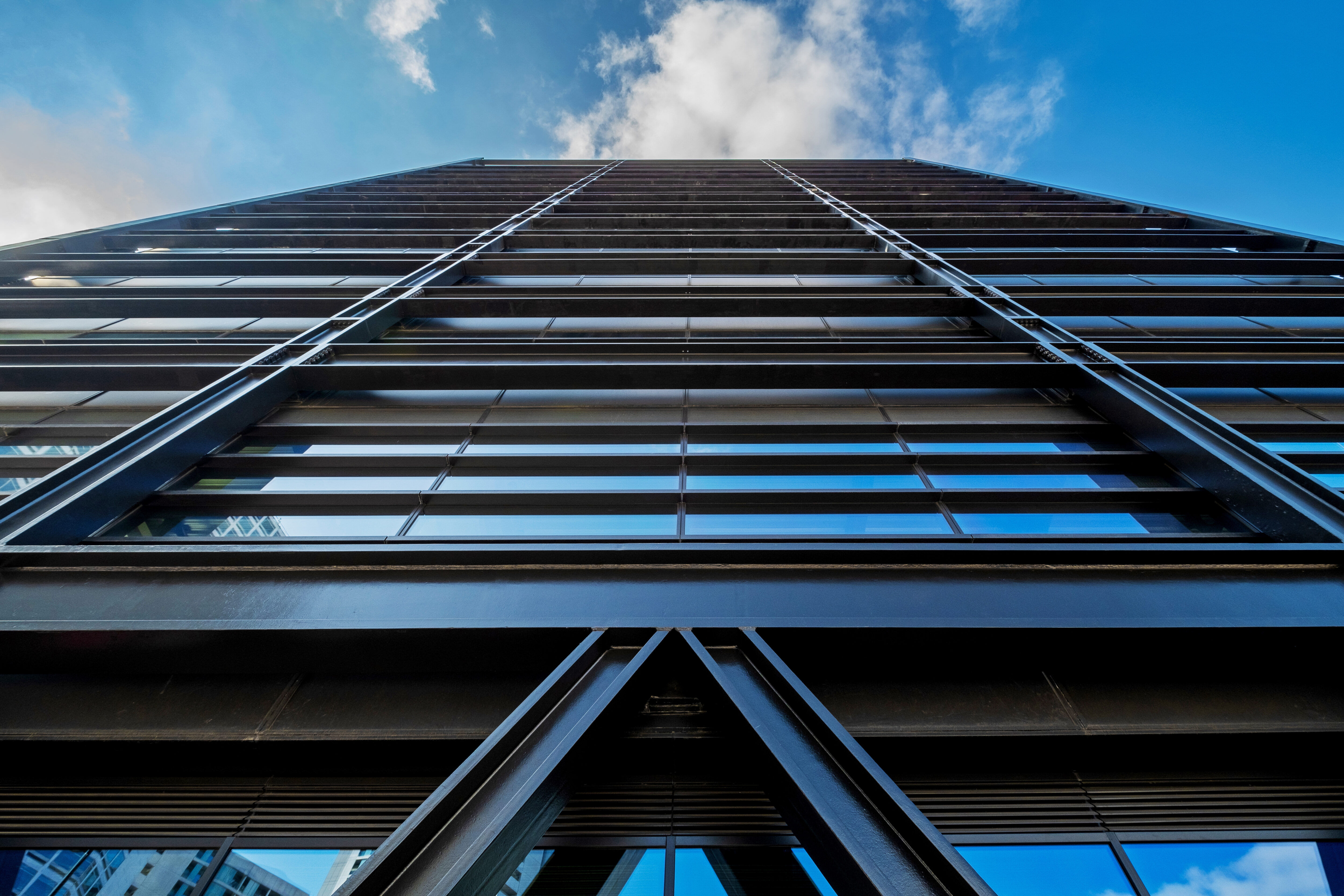 A photograph looking up from the ground at the facade of One Centenary Way