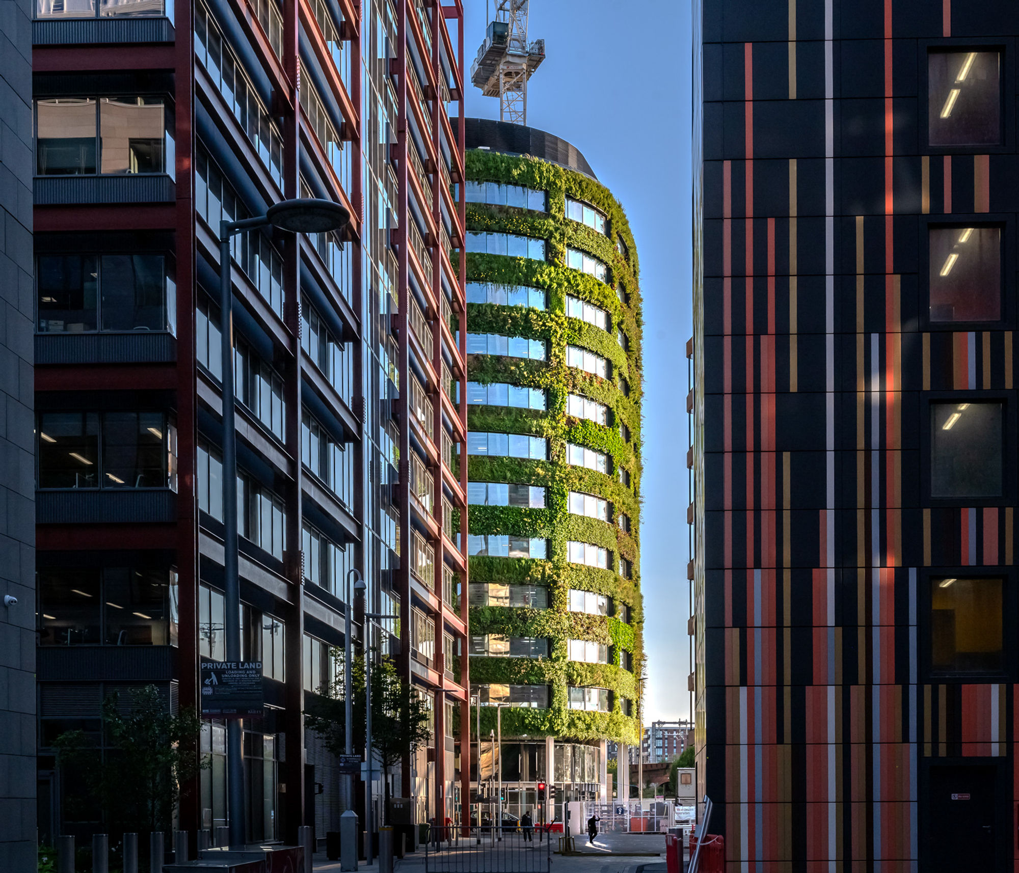 A photography of Eden New Bailey and its green living wall with other buildings in the foreground