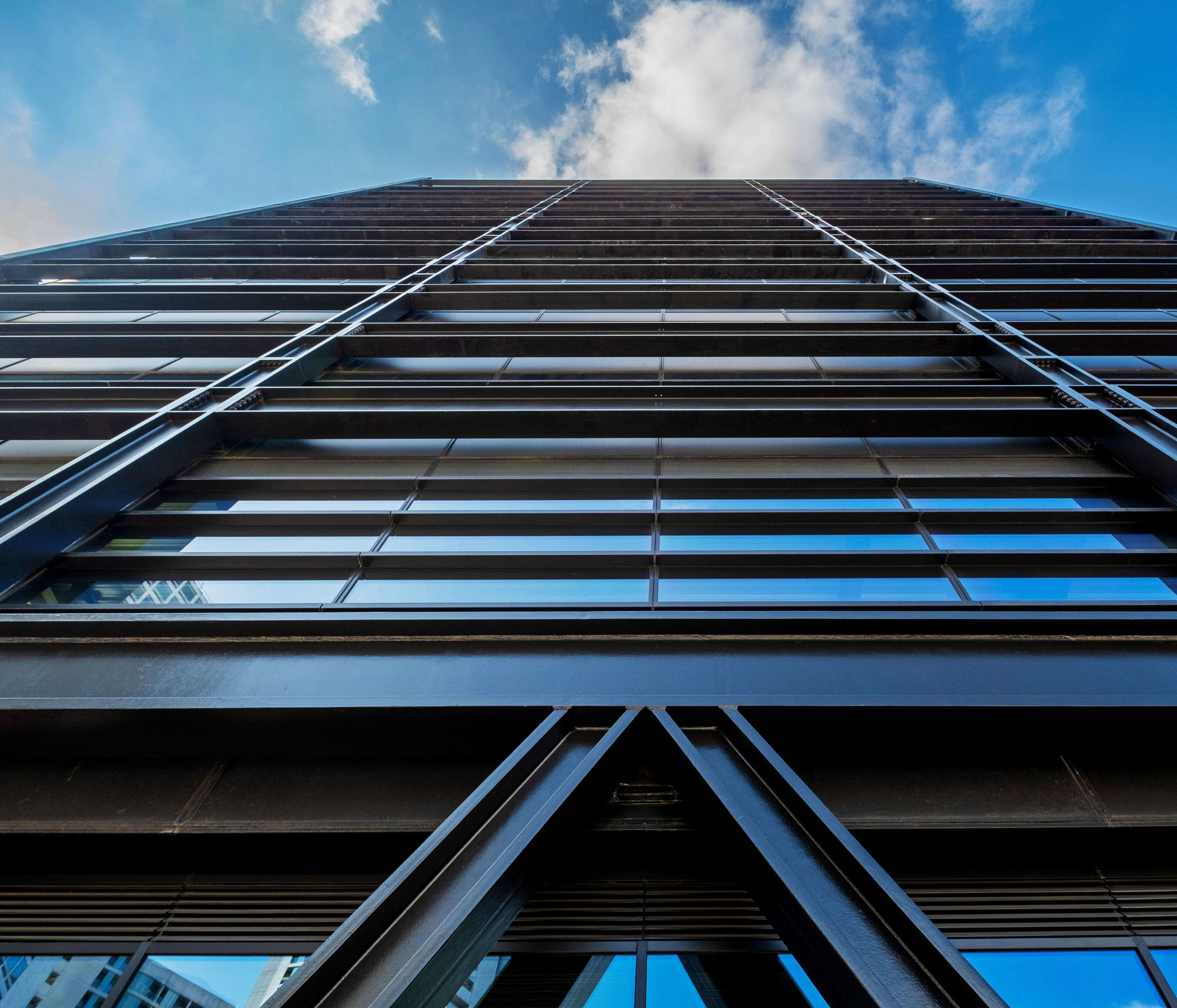 A photograph looking up from the ground at the facade of One Centenary Way
