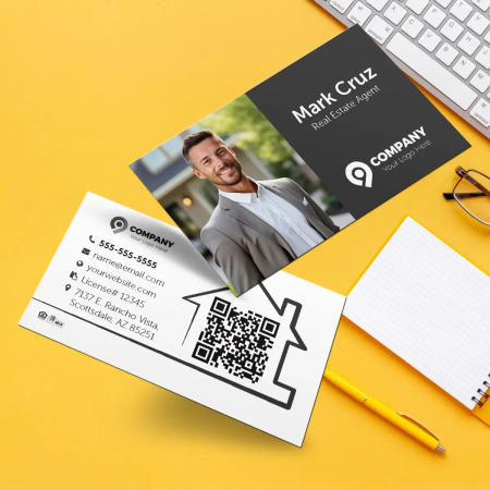 Real estate horizontal business cards with a coffee cup in the background.
