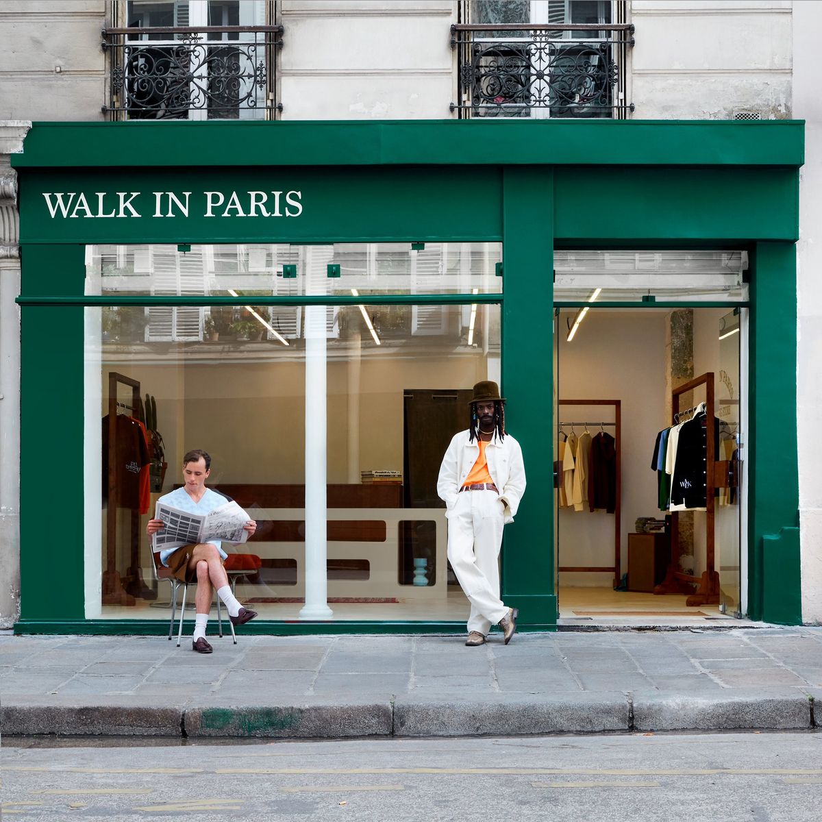 People outside the green Walk in Paris storefront