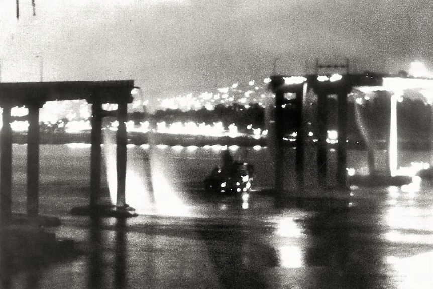 The SS Lake Illawarra sinking into the River Derwent after hitting the Tasman Bridge at 9:27pm. Photo gifted by the photographer to John Sargent. ⌘