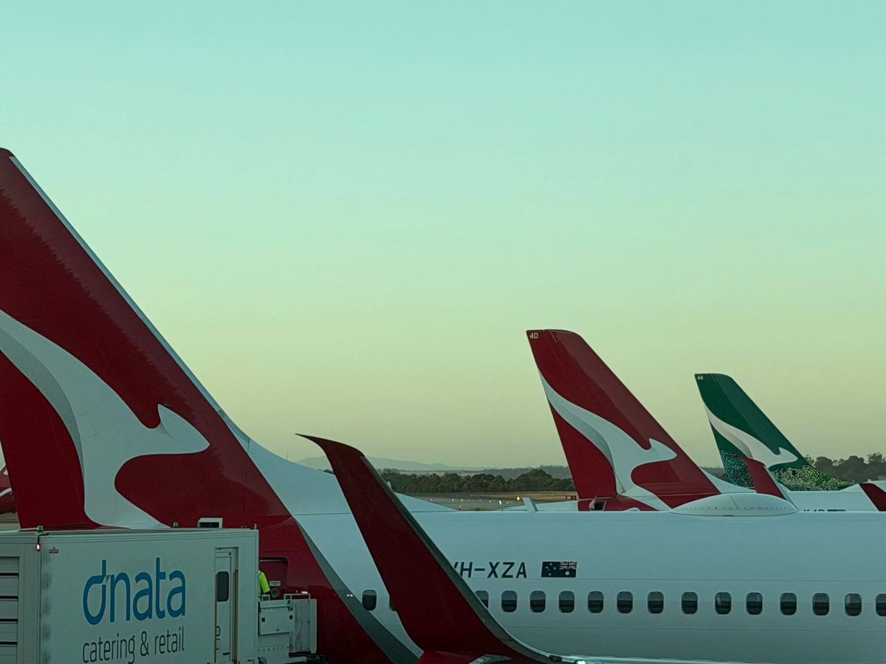 Airplanes with red and white tails at an airport