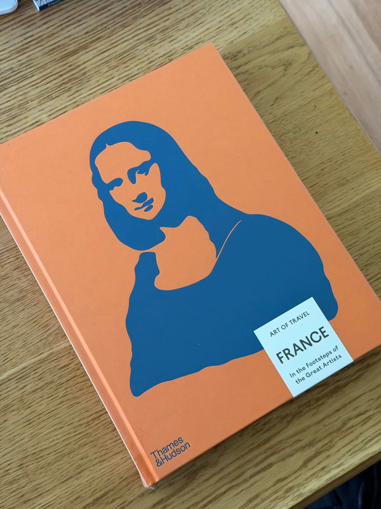 Orange book cover ofArt of Travel's second book, France: In the Footsteps of the Great Artists