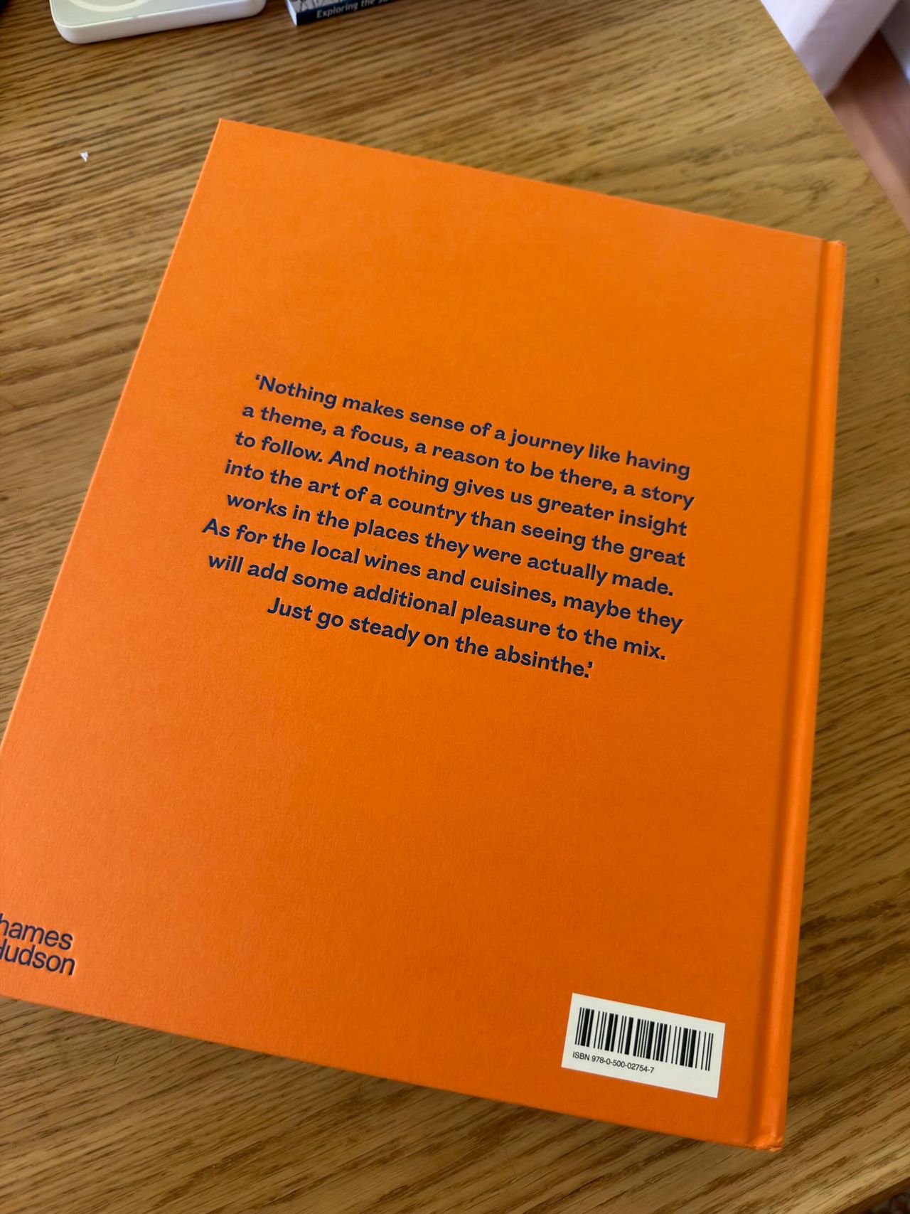 Book titled ‘Art of Travel‘ France: In the Footsteps of the Great Artists’ on orange and blue cover
