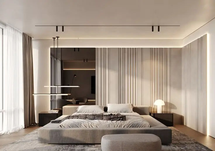 This may contain: a large bed sitting on top of a wooden floor next to a white chair and ottoman