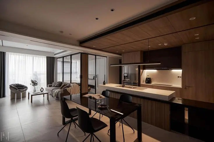 This may contain: a kitchen and living room with sliding glass doors that open up to the dining area