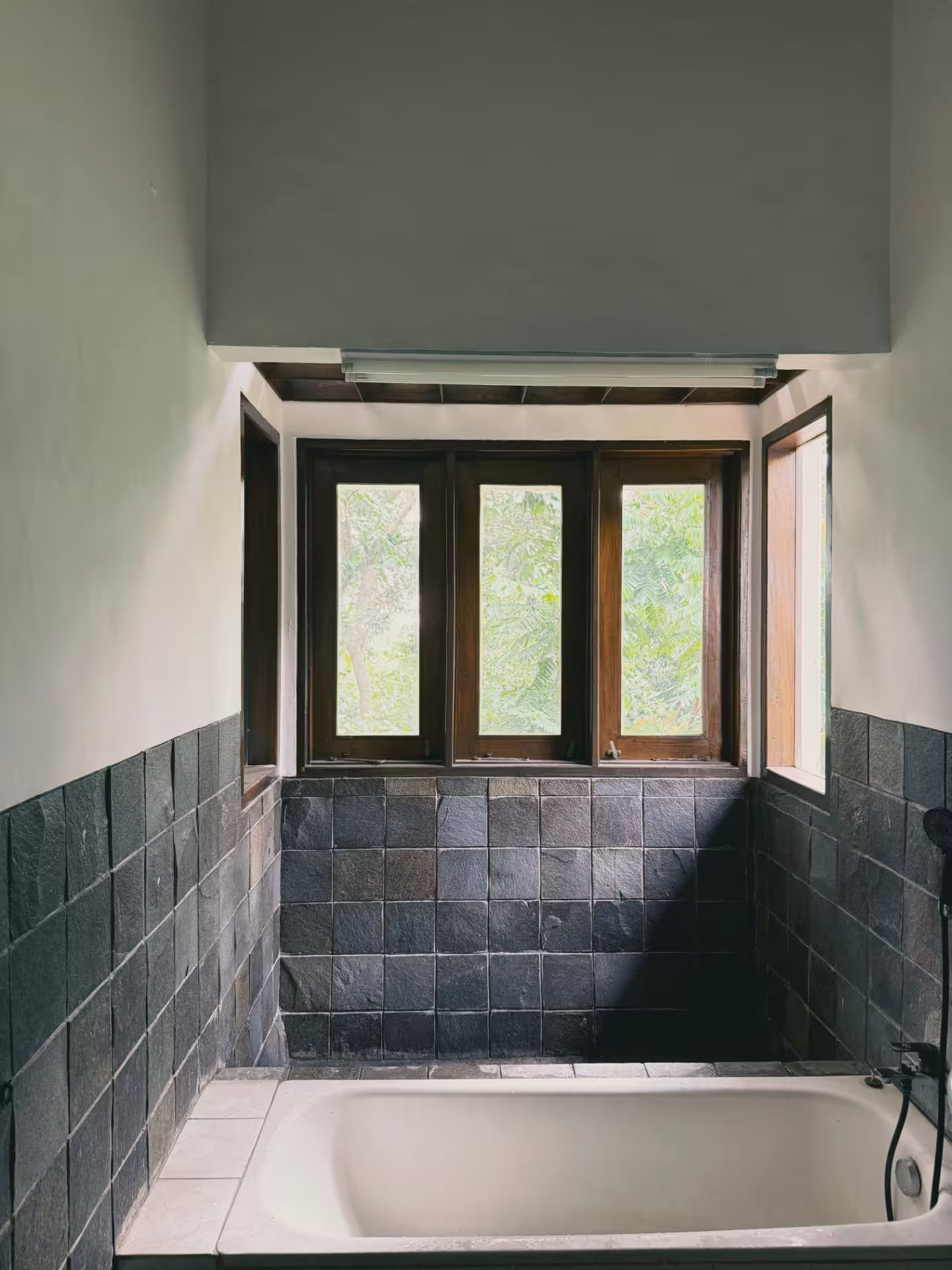 Kamar mandi dirumahdelima dengan material batu alam yang organik dan estetik