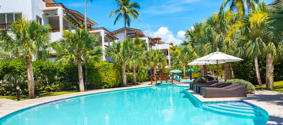 Complejo residencial de lujo Xeliter Balcones del Atlantico en Las Terrenas, con villas blancas de estilo caribeño, jardines tropicales y piscina