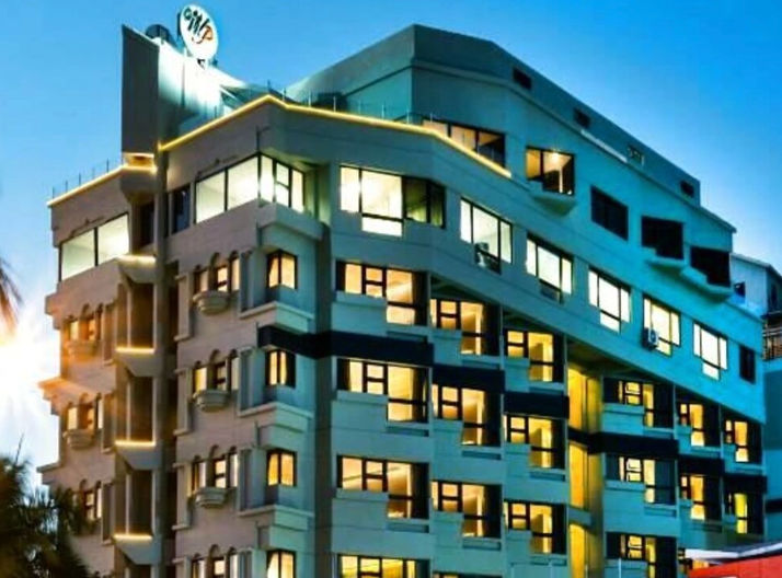 Illuminated exterior facade of the W and P Santo Domingo hotel during dusk in the Dominican Republic.