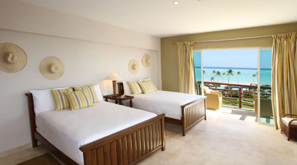 Oceanfront infinity pool and luxury suite buildings at Punta Palmera Cap Cana by Essenza Retreats