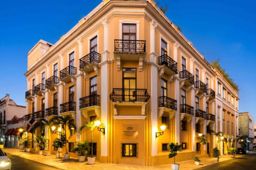 Illuminated facade of Gran Hotel Europa at night showcasing colonial architecture in the Colonial Zone of Santo Domingo