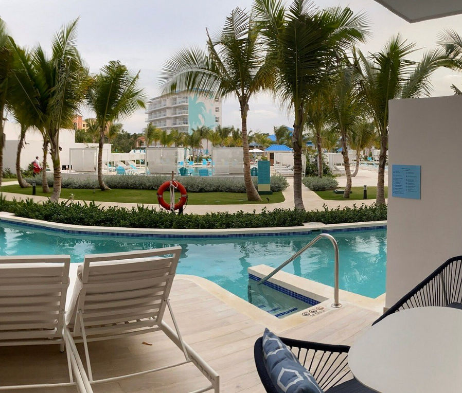 Aerial view of the swimming pools and tropical grounds at Ocean Blue & Sand Beach Resort
