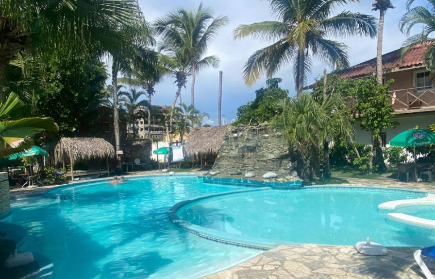 Fachada exterior y jardines tropicales del Plaza Real Resort en Juan Dolio