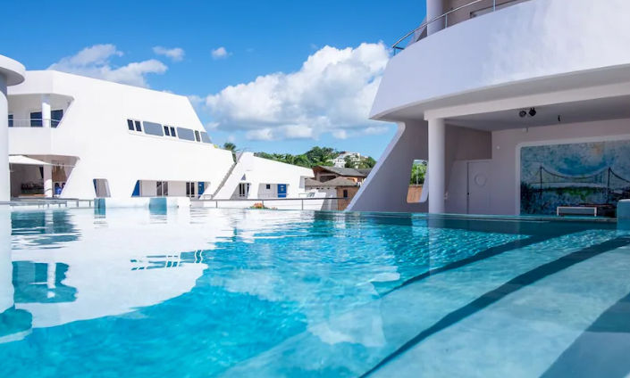 Aerial view of the unique boat-shaped architecture of Puerto Plaza hotel in Las Terrenas facing the Caribbean sea