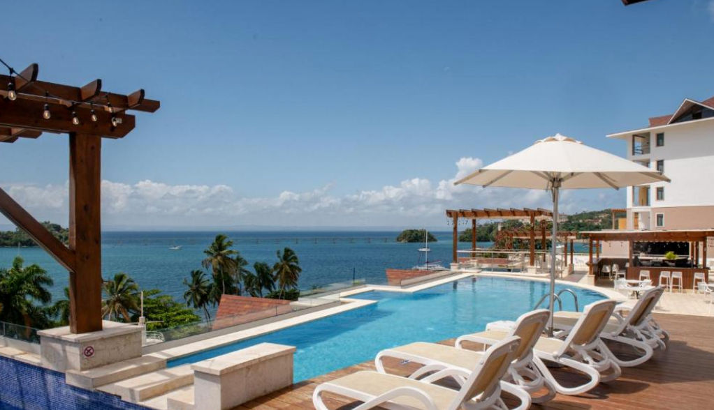 Aerial view of the facade and swimming pool of Hacienda Samana Bay Hotel Residence in Samana, Dominican Republic