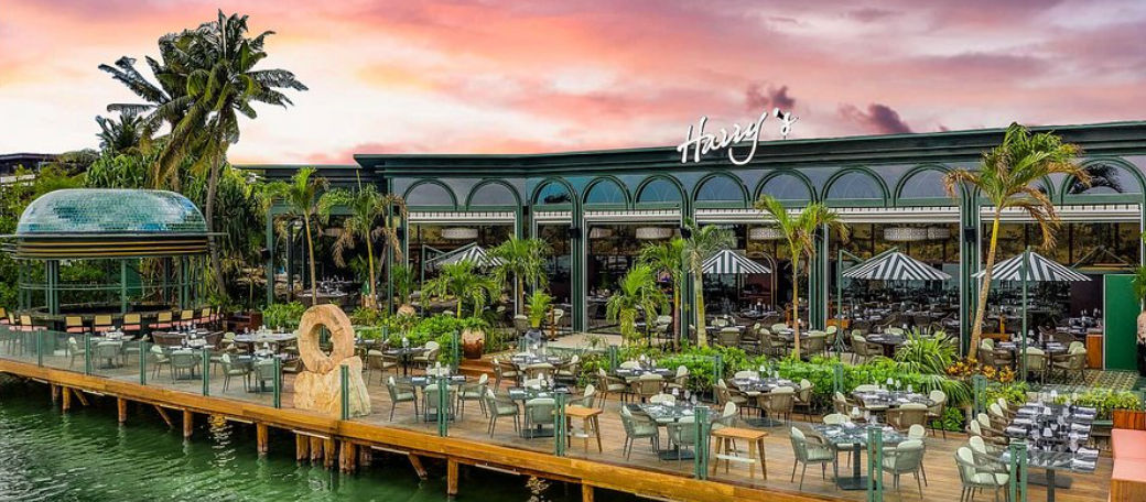 Terraza del restaurante Harry's en Cancún sobre la laguna al atardecer, el destino perfecto tras usar taxis desde el aeropuerto de Cancún al hotel