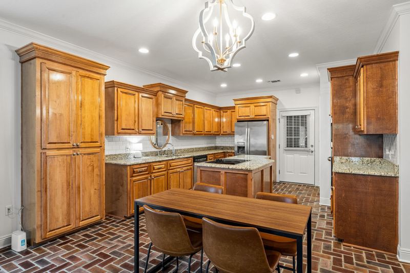 Kitchen with granite counters and island cooktop