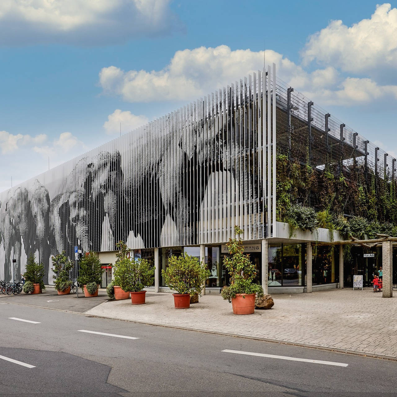 Tiergarten multi-storey car park with eye-catching facade featuring elephants and flower pots in the foreground
