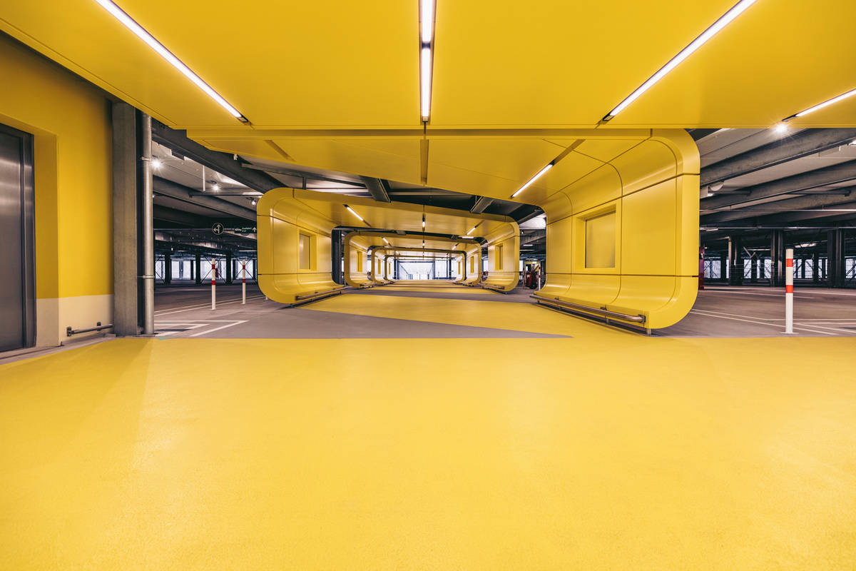 Bright yellow interior of the T3 Frankfurt multi-storey car park