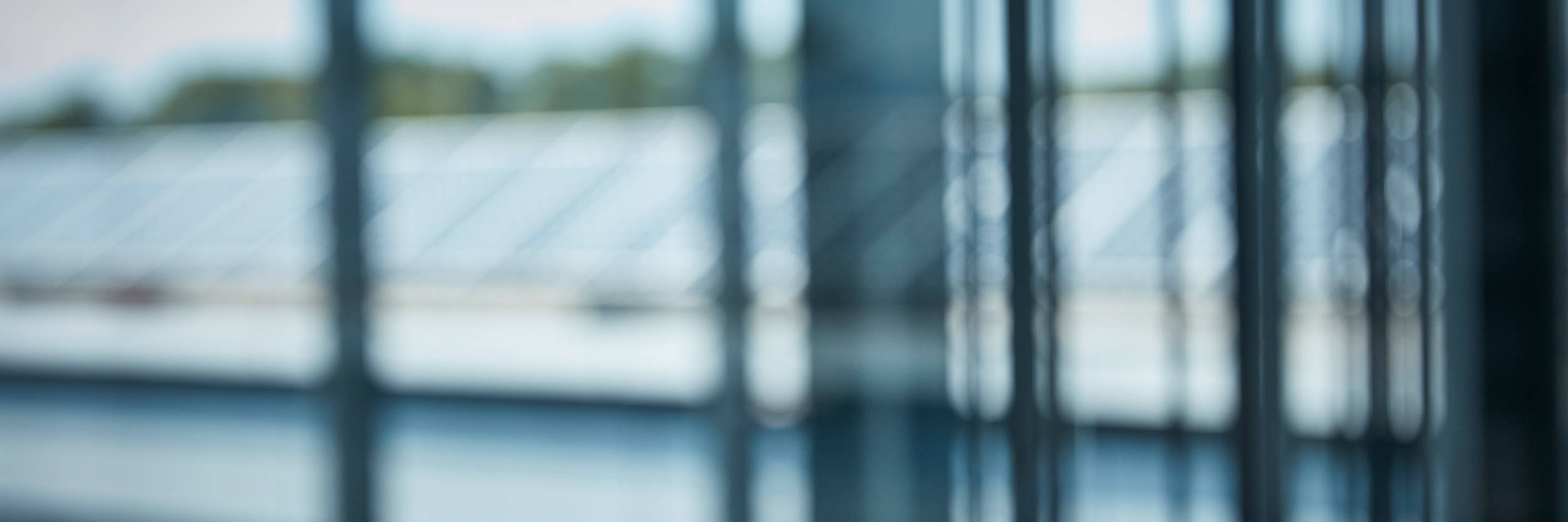 Blurred view of a building through a glass window.