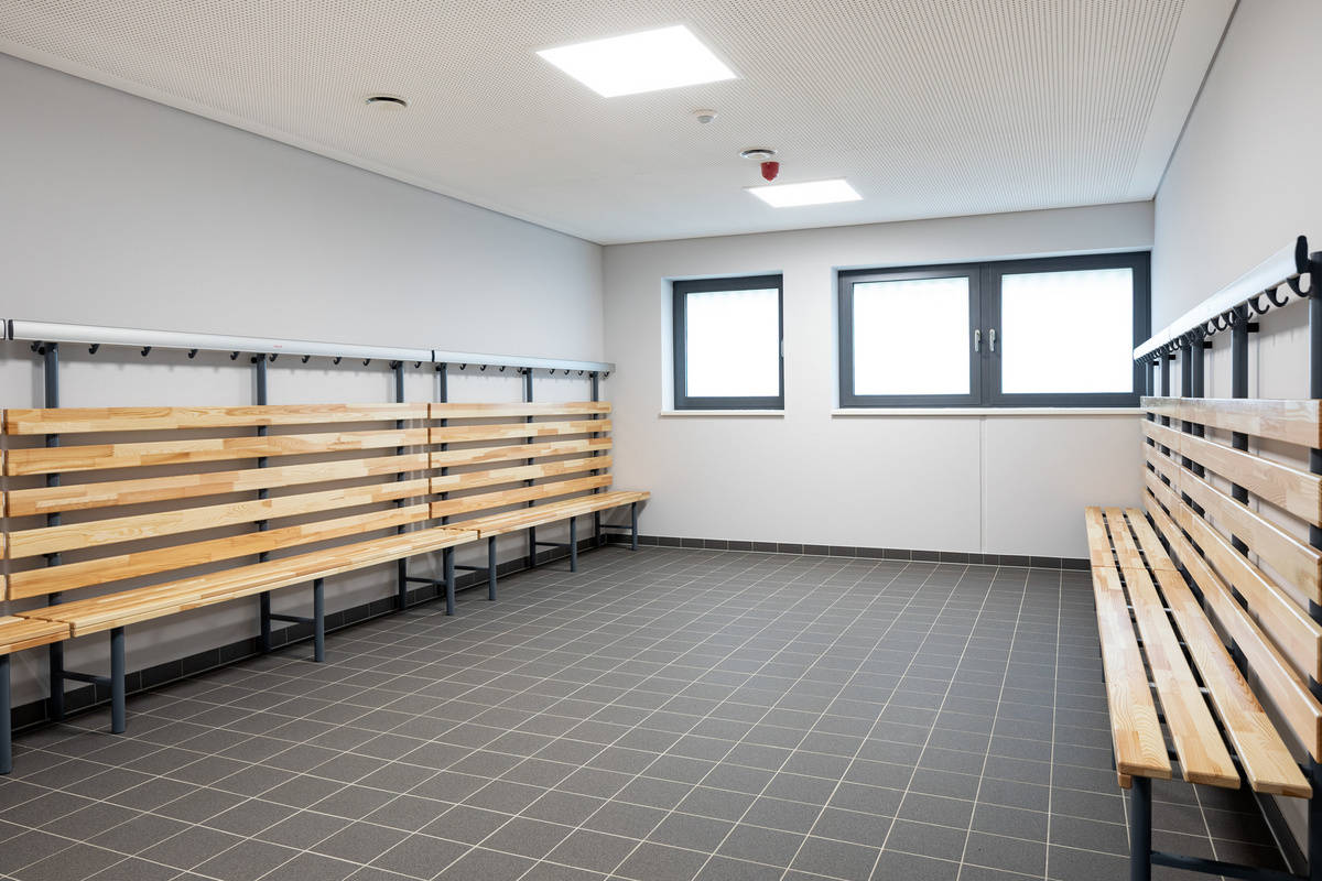 Interior view of the sports hall reference “Grüner Campus“ with a view of a changing room