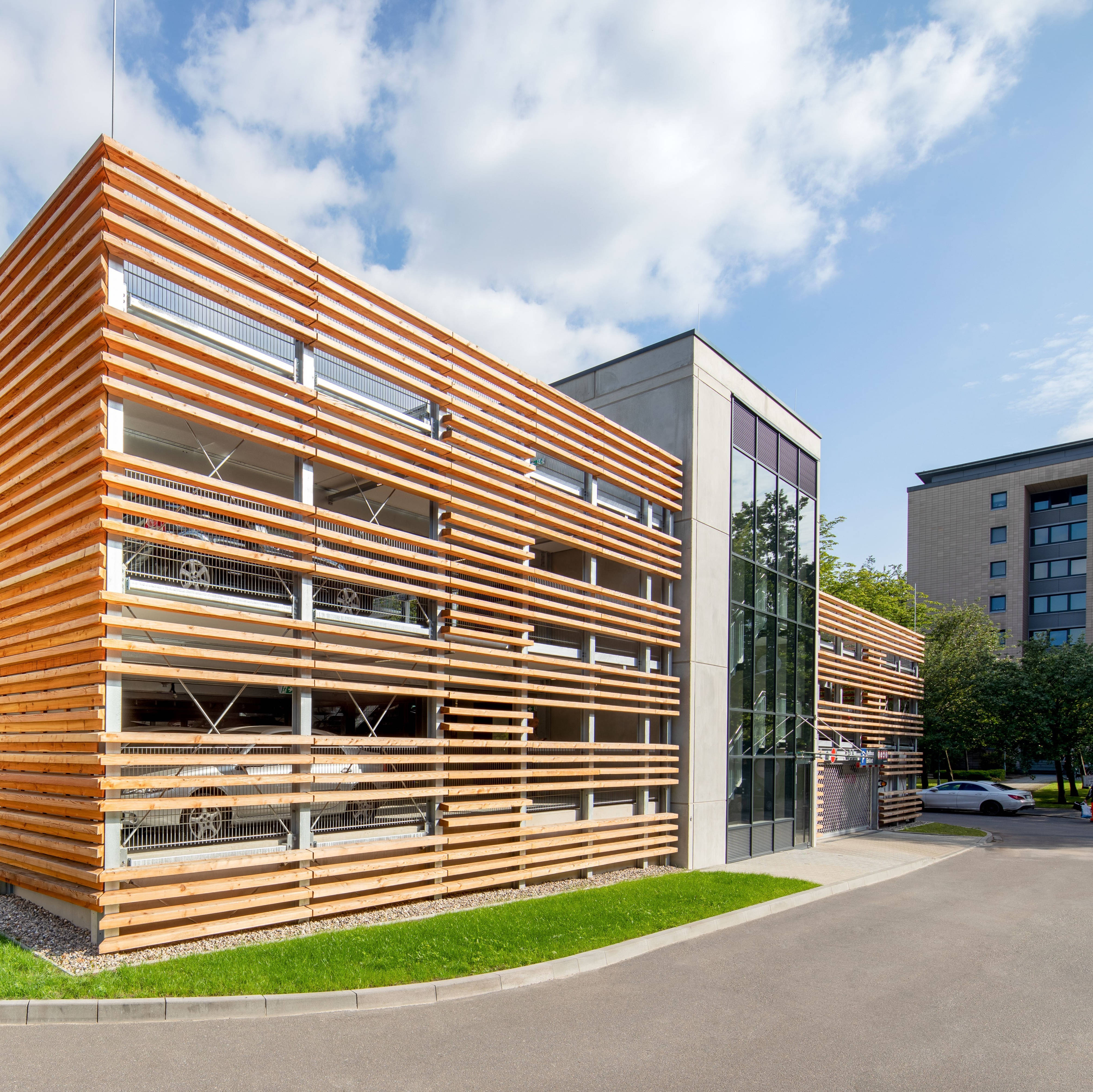 Modern urban multi-storey car park that impresses with wooden slats and glass windows and exudes an elegant, contemporary aesthetic.