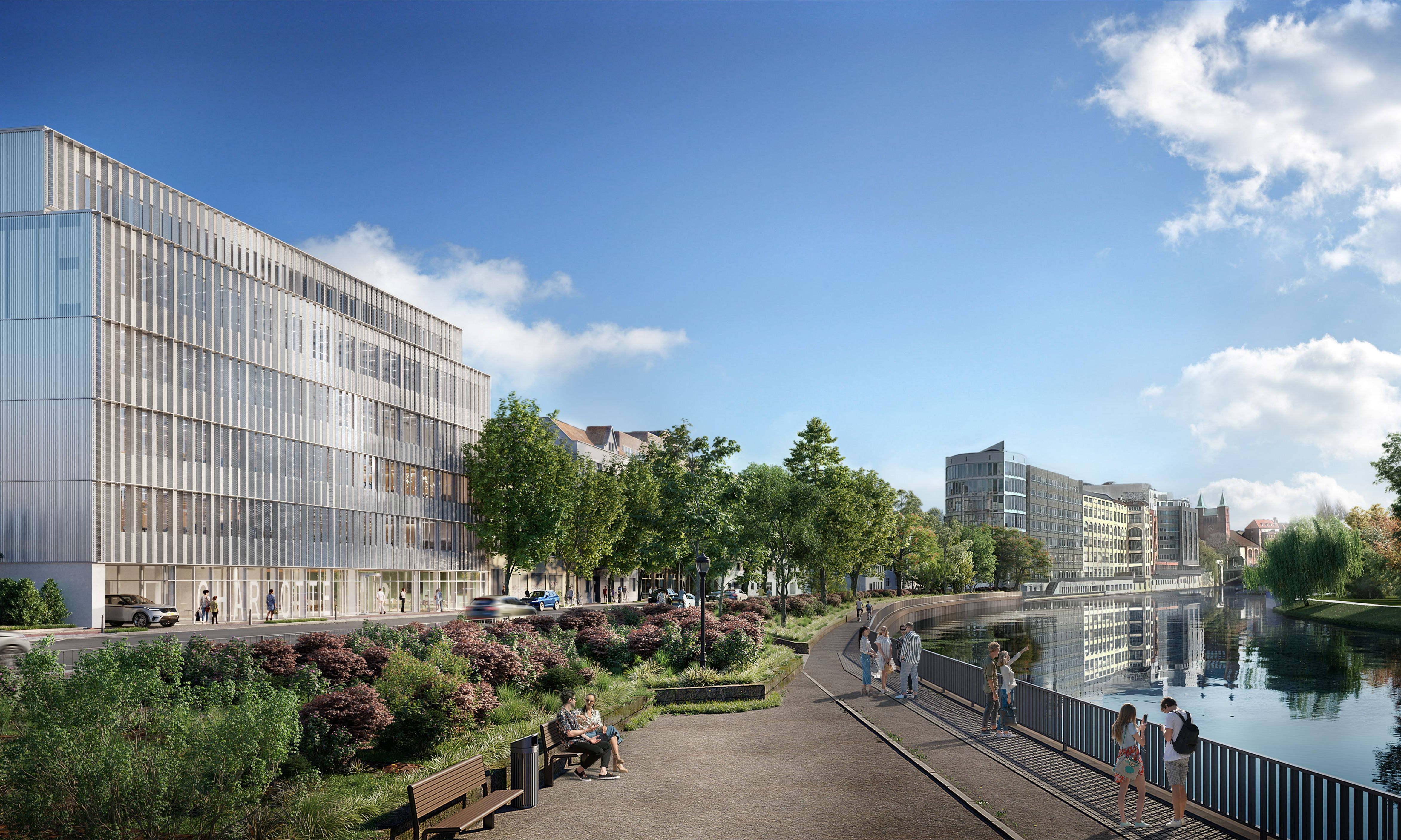 Moderner Bürokomplex an einer malerischen Flusspromenade mit Grünflächen und Spaziergängern bei sonnigem Wetter.