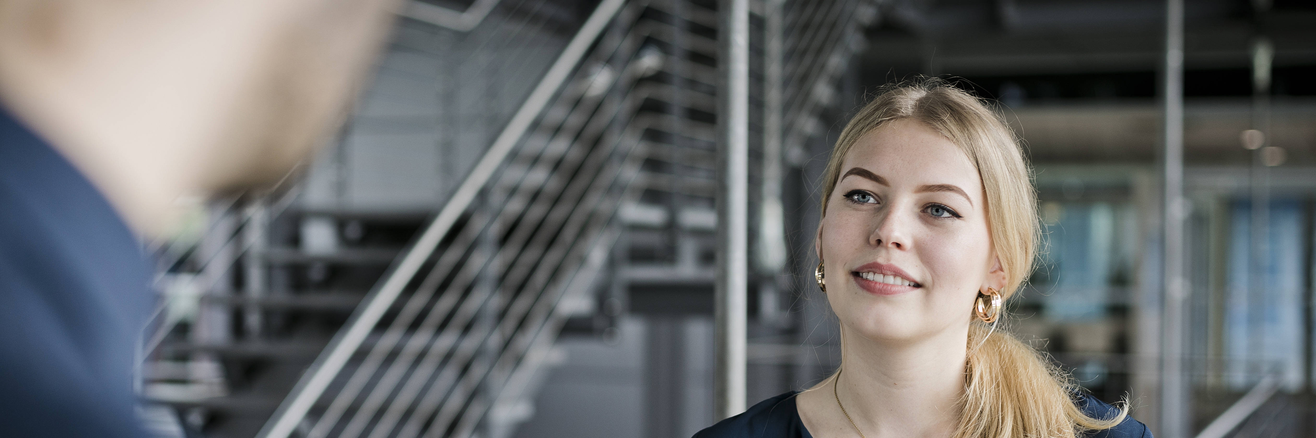 young woman with blonde hair in the stairwell