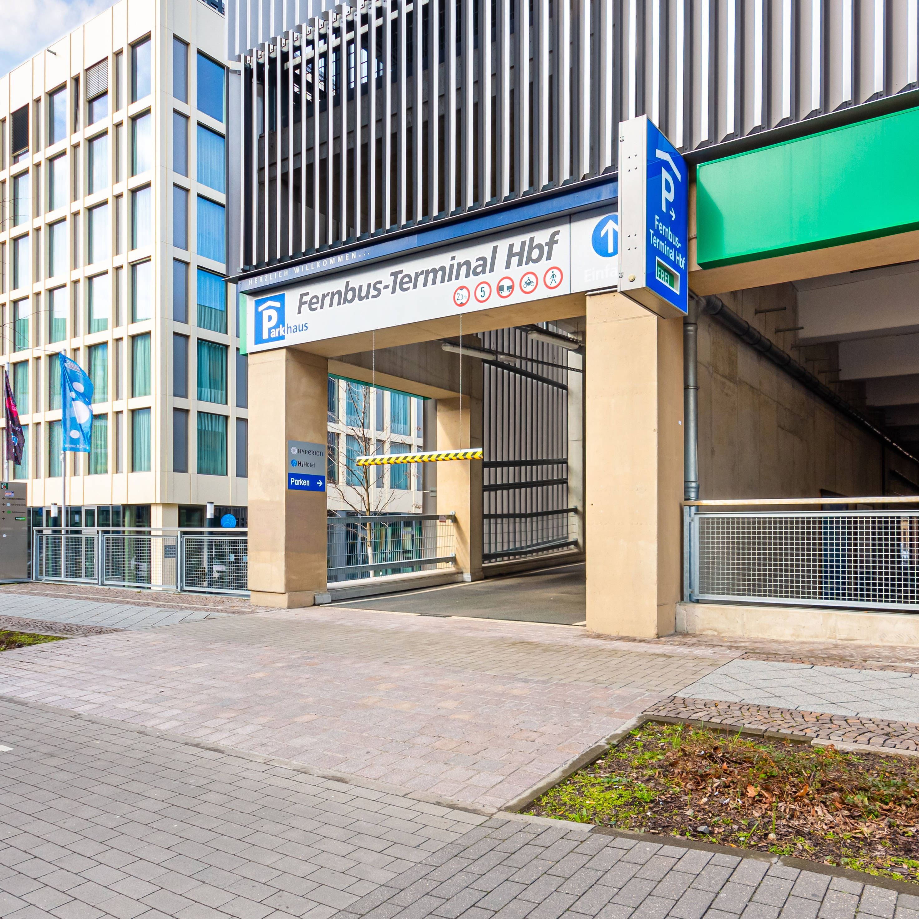 Entrance to the parking garage of the long-distance bus terminal at the main station with signs for parking and Europcar.