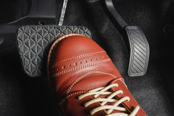 driver pressing the brake pedal